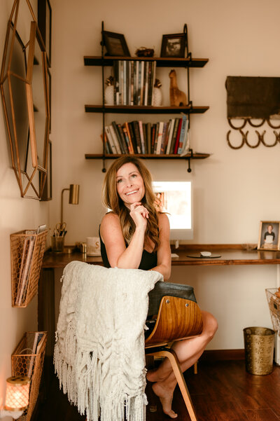 Shannon Kathleen Photography, Minneapolis photographer for dating and branding, seated in cozy home office space with coffee and notebook.