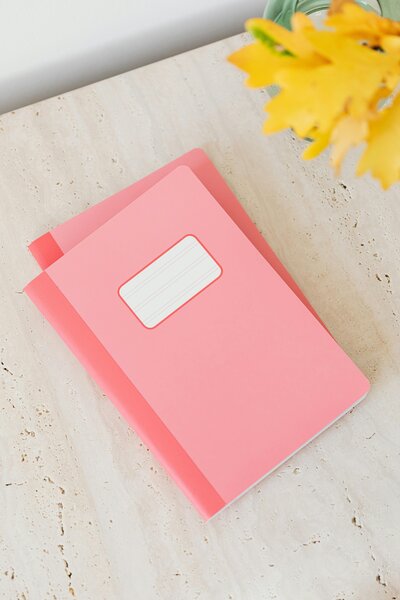 Pink jounals on a table