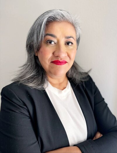 Tailored career advice for women in male-dominated industries, featuring a professional career coach sitting confidently at a desk, equipped with a laptop, notebook, and motivational tools to empower women in their career journeys.