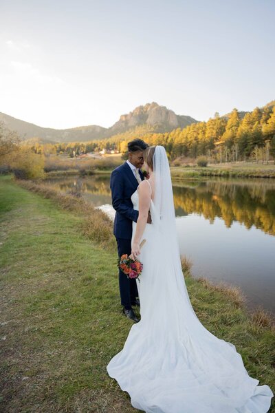 two brides in front of the Colorado mountains and lake
