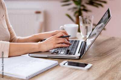 looking down on a table is a laptop with a woman's hands resting on the keyboard with her coffee and phone beside it photography mentorship photography classes hagerstown maryland frederick maryland chambersburg pennsylvania