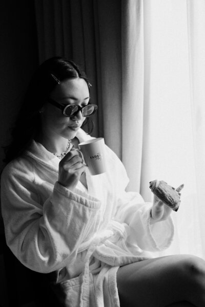 Bride eating croissant before Paris elopement