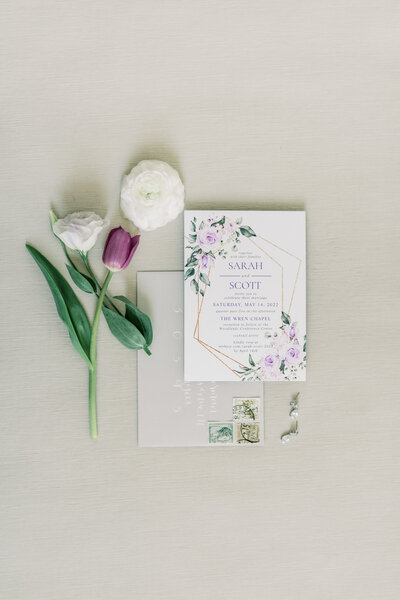 Detail photo of vintage-inspired invitation suite with old-timey stamps and floral accents, captured by Morgan Renee Photography for a Colonial Williamsburg wedding
