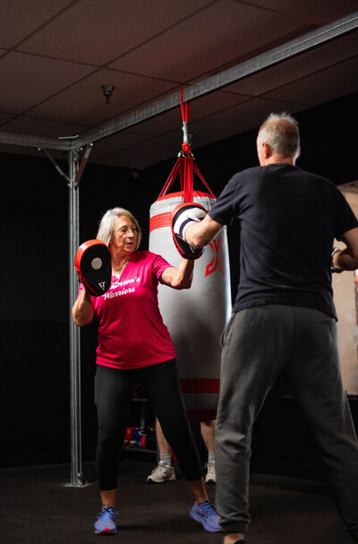 Trainer Lori of OPWF works with a Parkinson warrior in her Parkinson's boxing program. 