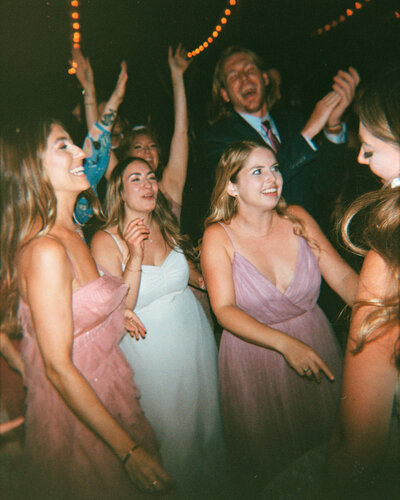 Bride on wedding guests shoulders during dance set at Glen Foerd Estate in Philadelphia, PA