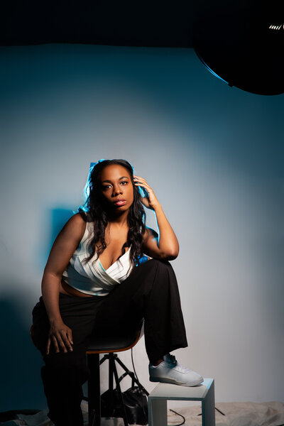 Portrait of photographer. Confident pose, editorial lighting, modern aesthetic.
