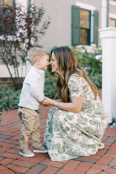 mom touching noses with son during family photo session
