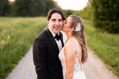 Bride kissing groom on the cheek