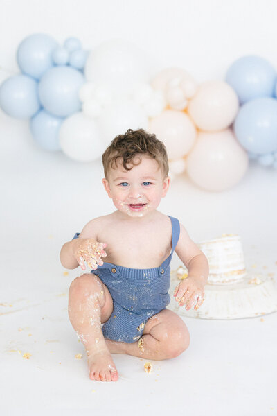 Mom snuggling her swaddled newborn in a bright northern kentucky newborn photography studio