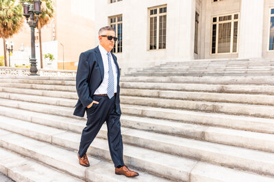 Man in a suit walking on steps
