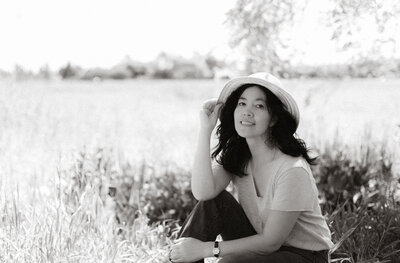 Black and white portrait of a woman looking at the camera outdoors, captured in natural light in Canyon Lake, California.