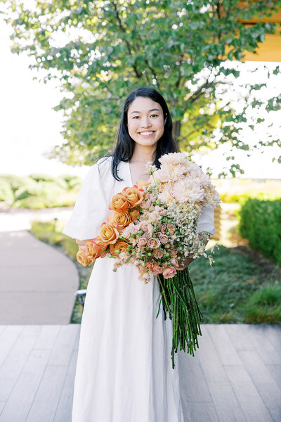 portrait of bay area luxury wedding florist holding flowers