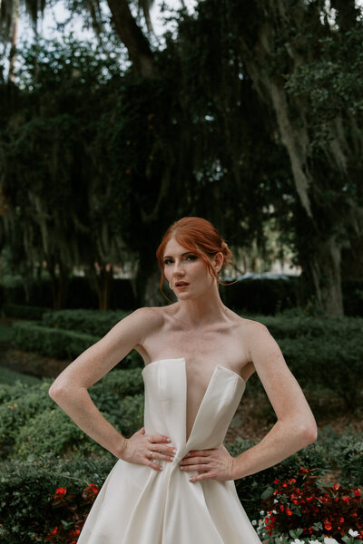 Black and white editorial portrait of couple under a wrought-iron arch, captured by a Florida wedding photographer specializing in moody, timeless imagery