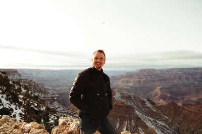 Photographer smiling portrait with Grand Canyon  view behind him