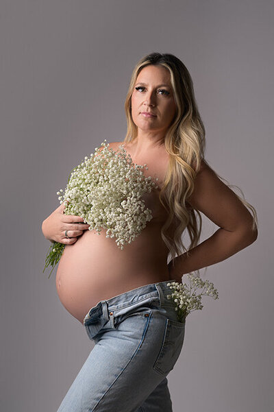 Boston studio maternity portrait of woman in jeans and white top