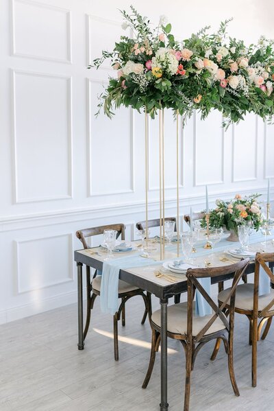 wedding reception design with large floral tall centerpiece
