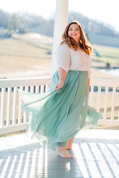 Owner and social media manager for women's empowerment movement called The Skirt Project smiles and swishes her large tulle skirt during the lifestyle portion of her social media photoshoot