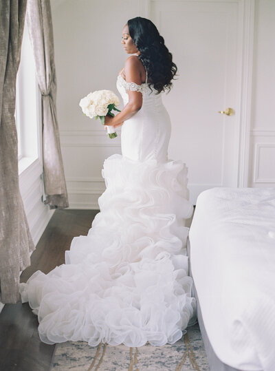 a bride looking at her wedding dress