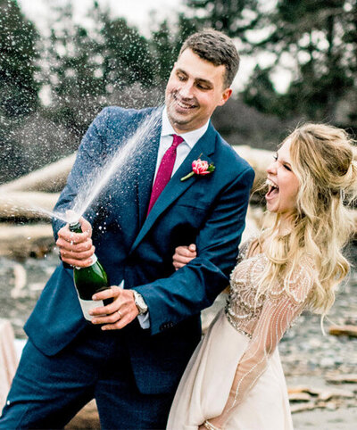 A groom pops champagne during his wedding reception elopement photo shoot.