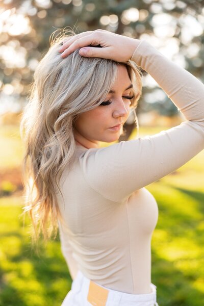 High School senior girl snuggling in sweater