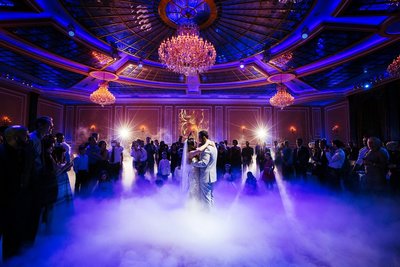 Married couple have their first dance amongst the ground fog