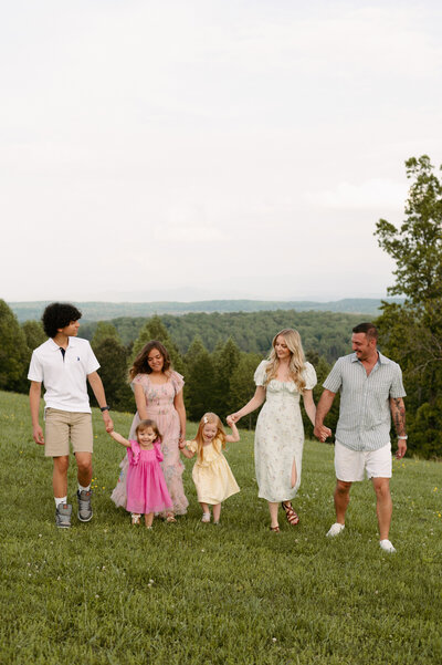 A family poses for a photo at sunset.