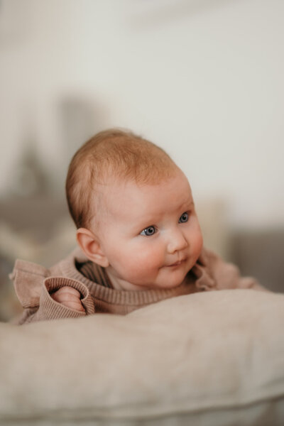 A newborn leans on a pillow - Newborn Photographer Karin Busch Los Angeles.