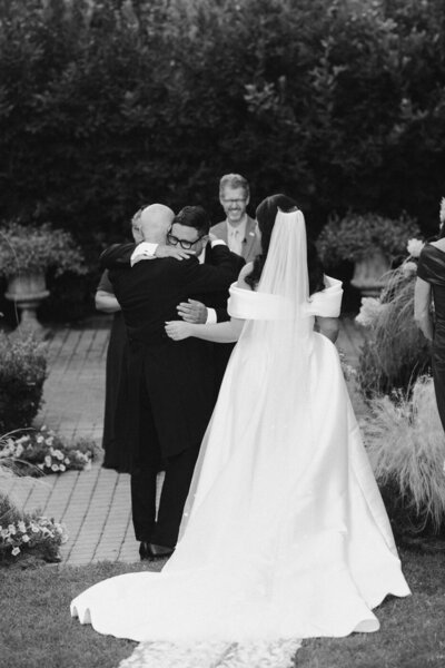 groom hugs father of the bride during wedding at the madrona in healdsburg, ca