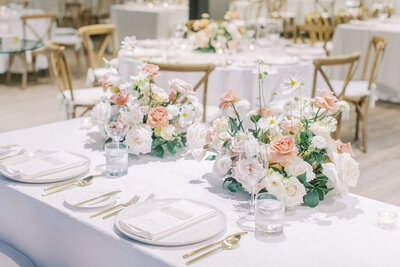 Gorgeous wedding reception tablescape, featuring pink and white roses, designed by CNC Event Design, wedding planner in Calgary, Alberta, featured on the Brontë Bride Vendor Guide.
