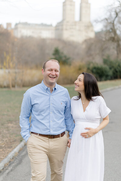 Pregnant couple walking outside in NYC for maternity photos