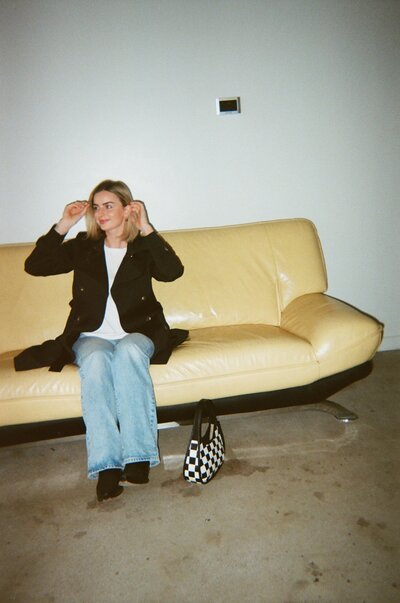 Jaiden sitting on yellow couch in photo studio