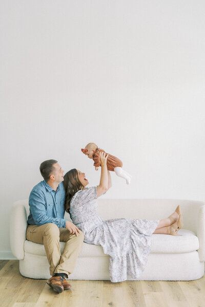 family playing together on the couch during family studio photo session