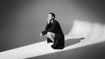 Jasmina Kimova in a sculptural black and white editorial portrait, representing cinematic storytelling, creative direction, and multimedia artistry.