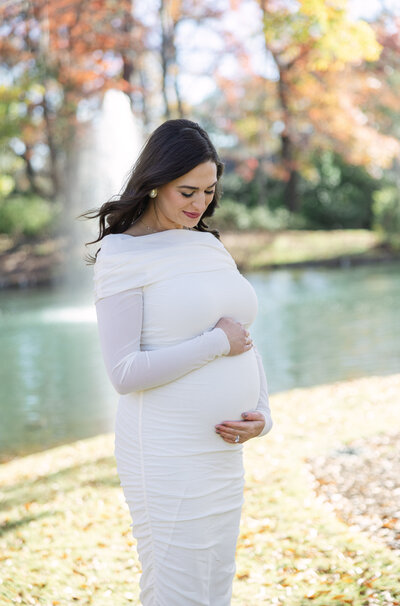 Maternity Photo of a mom looking down and holding her belly