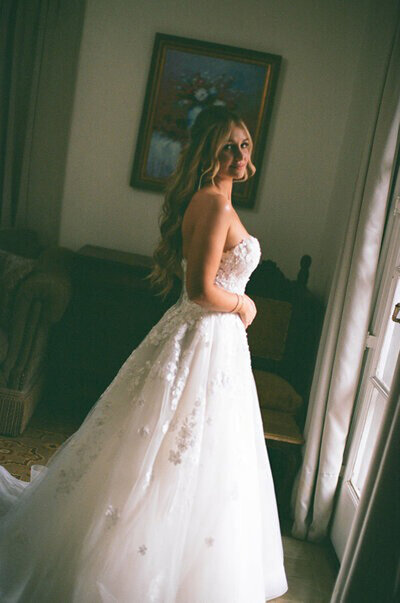 Bride standing by window taken by orlando wedding photographer, Marissa Nicole
