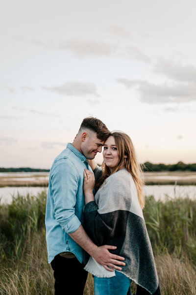 couple embracing in a field