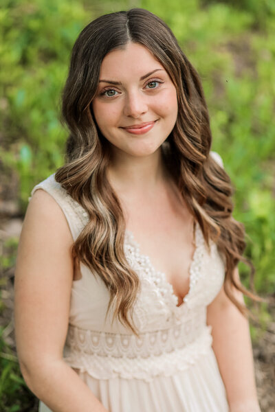 Girl in white dress looking at the camera | Senior Portraits