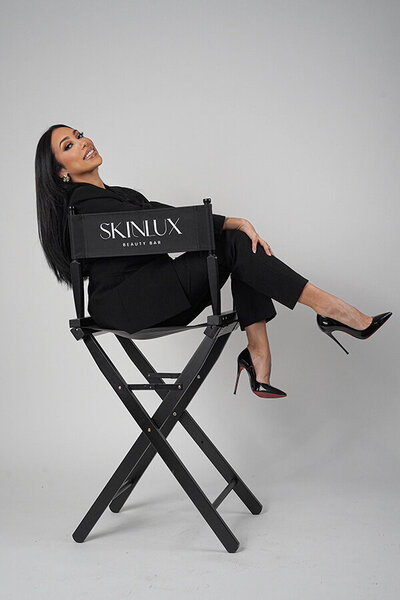 Luxury makeup artist in NYC dressed elegantly with professional skincare products ready to teach women how to do their own makeup