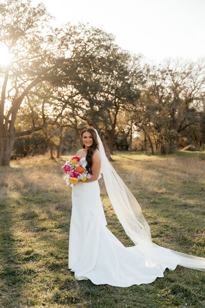 bride posing on wedding day  at sunset