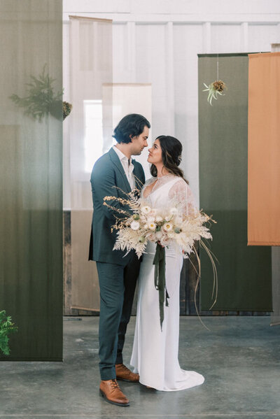 Fabric and kokedama hanging ceremony backdrop captured by Pam Kriangkum Photography, fine art, classic wedding photographer in Edmonton, Alberta. Featured on the Bronte Bride Blog.