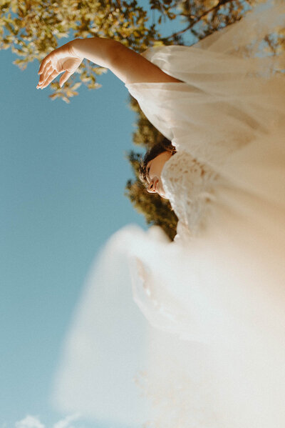 upward view of bride in wedding dress