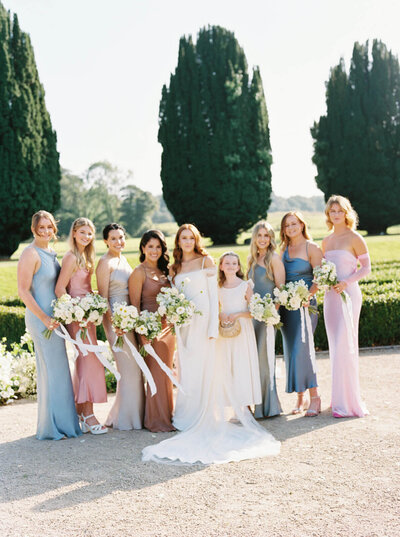 Film photo of the bride & her bridesmaids in their silk dresses in the gardens of Castlemartyr