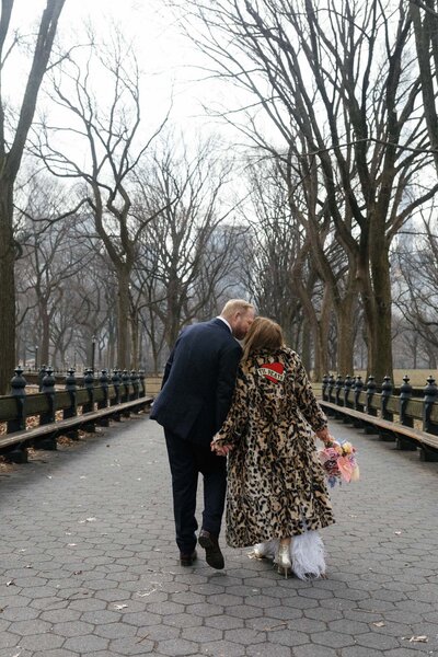 winter central park elopement at the mall and literary walk with faux fur coat
