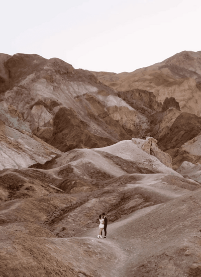 Couple in an embrace at Artist's Palette while standing on a path