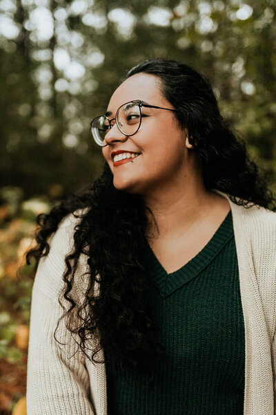 woman with glasses smiles