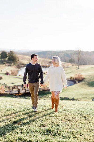 couple engagement walking hand in hand vineyard