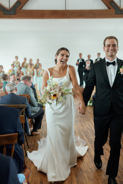 Caroline and her husband Crawford recess down the aisle on their wedding day