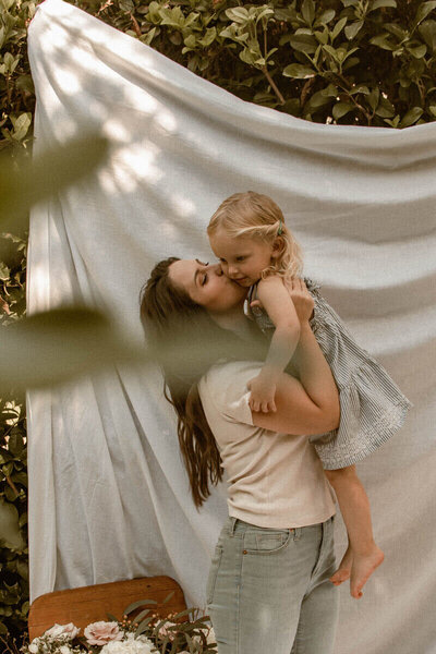 Samantha Schultz kissing her young daughter