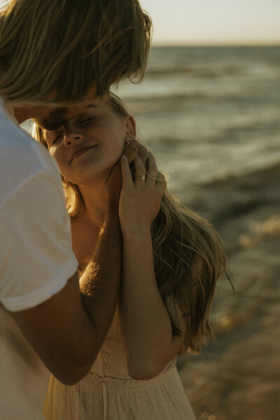 Romantic engagement photos at sunset on Lake Michigan.