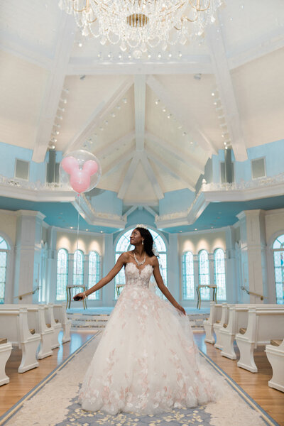 Bride holding Mickey balloon in Disney's wedding pavilion